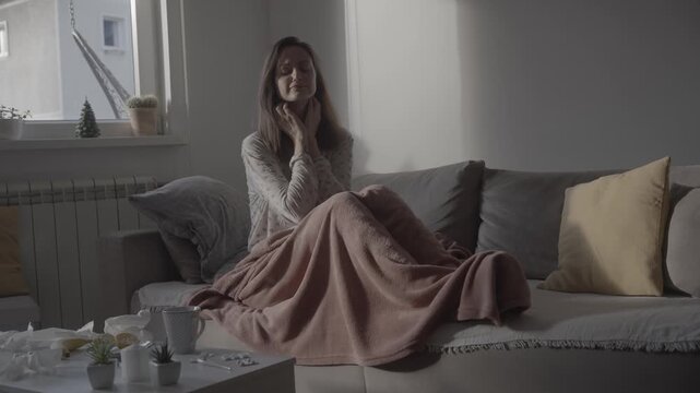Young sick woman with suffering from fever with shivering and chills