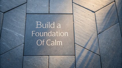 Inscribed stone block with words urging a calm foundation