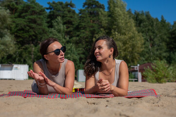 Fototapeta premium Two Caucasian women relaxing on the beach. 