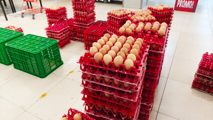 Stack of egg stock in a red egg tray, displaying poultry farm products ready for sale.