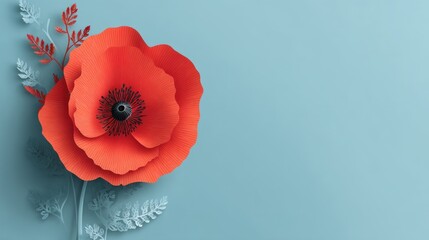 A large red poppy flower is set against a light blue background. The flower has detailed paper petals and is accompanied by subtle green leaves. This setup showcases craft and design.