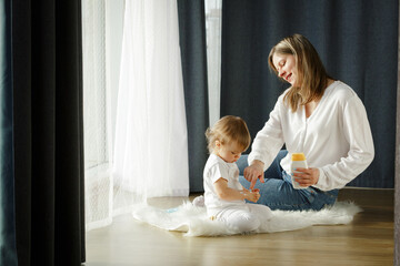 Pretty woman blowing candlelight on a chocolate donut, happy birthday celebration. 