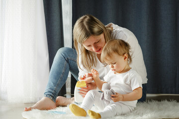 Pretty woman blowing candlelight on a chocolate donut, happy birthday celebration. 