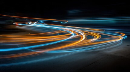 Light trails created by moving vehicles show a busy street at night. The bright colors of light contrast against the dark surroundings in an urban setting.