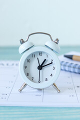 Alarm clock and calendar with white background. Close-up. Copy space. The concept of time, business goals, and future aspirations.