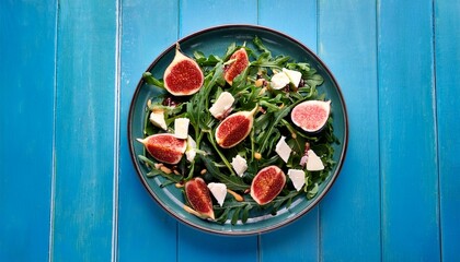 Fresh Arugula Salad Topped With Figs And Cheese On A Vibrant Blue Background
