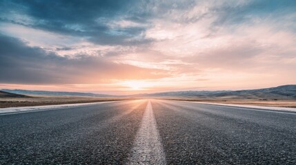 Empty asphalt road with subtle tire tracks leading into the horizon, wide open landscape, soft sunrise light, pastel orange and blue sky, dramatic