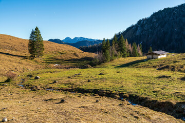 Chiemgau mountain valley landscape close to the Hochfelln peak during winter and autumn season