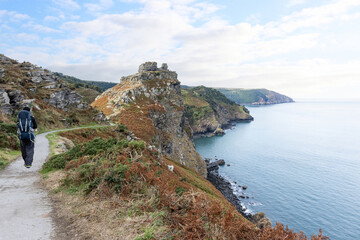 Backpacker hiking the South West Coast Path above the Valley of Rocks near Lynton, North Devon