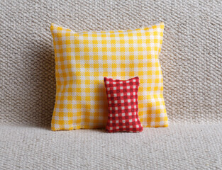 Yellow and red checked cushion on sofa
