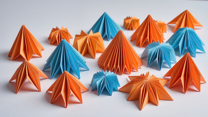 Origami art, meticulously folded abstract orange and blue geometric shapes made from paper, are arranged on a clean and minimalist background.