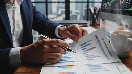 Business professionals review charts and graphs to analyze data during a strategic meeting. - Powered by Adobe