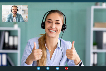 A young lady wearing headphones is smiling and giving a thumbs up while engaged in a video call on her PC. She is likely participating in a lesson or an interview, showcasing positive interaction.