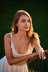 Slavic Woman in White Dress by Railing