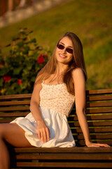 Slavic Woman in White Dress on Bench