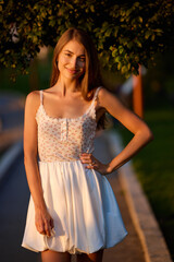 Slavic Woman in Sunlit Garden Wearing White Skirt