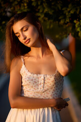 Slavic Woman in Sunlit Garden Wearing White Skirt