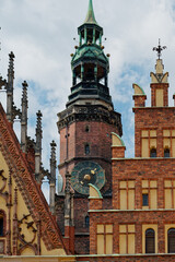 Fototapeta premium Detailed Perspective Of Medieval Clock Tower Showcasing Ornate Features And Aged Patinas Against Stormy Sky
