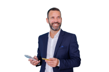 Man in a suit smiling, holding credit card and smartphone, online shopping and mobile payment concept