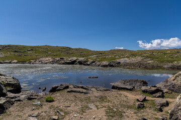 Fototapeta premium Beautiful alpine lake on the Emparis Plateau in the Arves Massif, Hautes-Alpes, France.