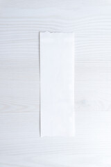 Blank receipt on white desk background, minimalist financial document concept with copy space for accounting, expense tracking, billing, or retail design use