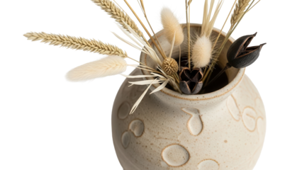 Close up of a textured ceramic vase with dried flowers decoration isolated on white background 