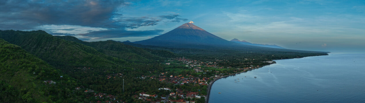 Aerial Panorama of Amed Coastline with Mount Agung and Black Sand Beach in Bali