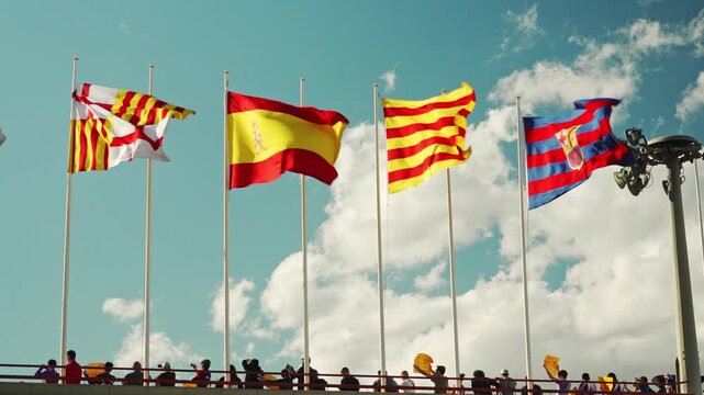 Multiple Flags Waving in Barcelona Sky