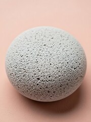 Monochrome pumice stone sphere displaying unique porous surface texture
