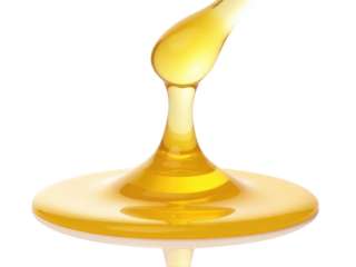 A single drop of honey falls from a spoon