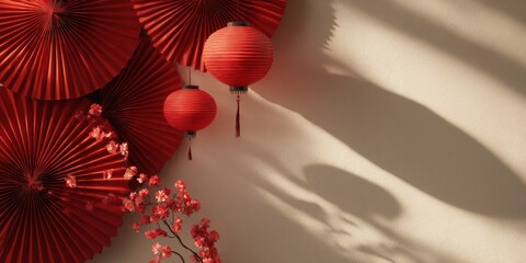 Festive red lanterns and paper fans with blossoms on a warm wall backdrop, creating a celebratory atmosphere