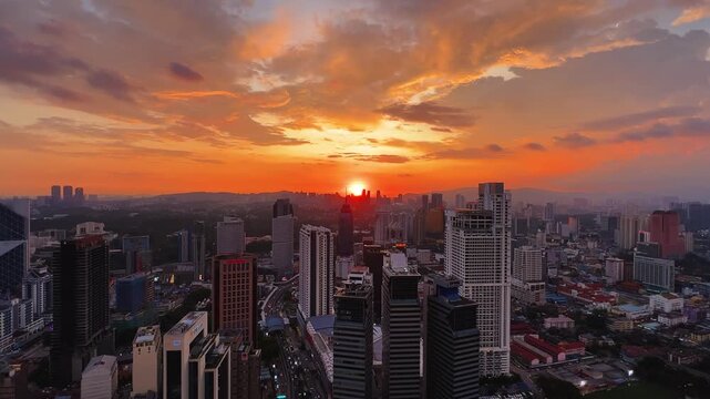 Kuala Lumpur, Malaysia, June 8, 2025: Sunset from an observation deck in Kuala Lumpur. Sunset sky illuminated by twilight, TV tower, and high-rise buildings from the air in the city center. 4K
