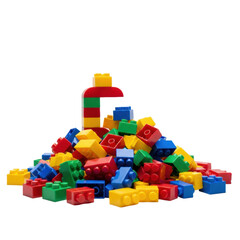 Fototapeta premium Chaotic pile of vibrant red, yellow, blue, and green glossy plastic toy bricks, macro shot on transparent background with bokeh effect, concept of childhood imagination and building