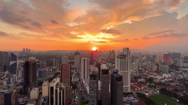 Kuala Lumpur, Malaysia, June 8, 2025: Sunset from an observation deck in Kuala Lumpur. Sunset sky illuminated by twilight, TV tower, and high-rise buildings from the air in the city center. 4K