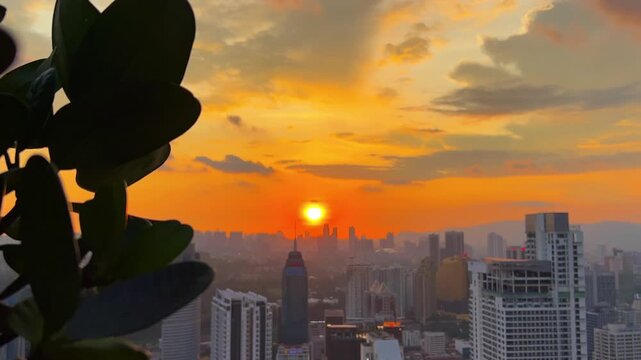 Kuala Lumpur, Malaysia, June 8, 2025: Sunset from an observation deck in Kuala Lumpur. Sunset sky illuminated by twilight, TV tower, and high-rise buildings from the air in the city center. 4K