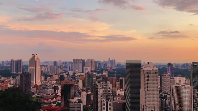 Kuala Lumpur, Malaysia, June 8, 2025: Sunset from an observation deck in Kuala Lumpur. Sunset sky illuminated by twilight, TV tower, and high-rise buildings from the air in the city center. 4K