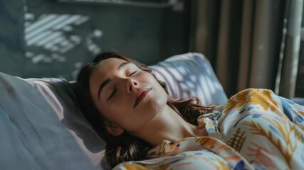 A woman sleeping peacefully on a bed with sunlight filtering through her window and creating beautiful patterns on the sheets.