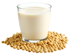 Glass of creamy plant-based milk surrounded by soybeans