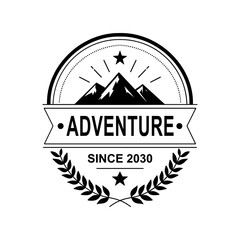 Vintage adventure mountain badge logo with laurel wreath and ribbon banner