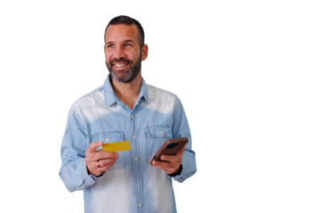 Happy man conducting online shopping, paying with credit card and smartphone, enjoying e-commerce services