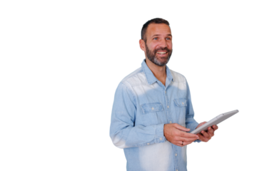 Bearded man smiling and looking up, holding a digital tablet in a casual denim shirt with transparent background