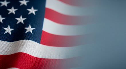Fototapeta premium Close-up of the American flag waving with stars and stripes in soft focus