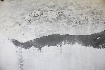 grunge concrete wall featuring a textured surface with faded paint, abstract details, and a distressed appearance, suitable for background or design element use.