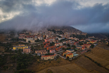 Sunrise view of the rooftops of Gangi with morning fog. Sicily, Italy. August 2024. Aerial drone picture.