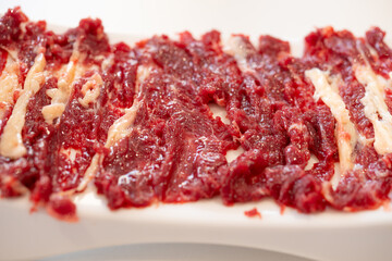 Obraz premium angle view raw fatty beef slices at horizontal composition