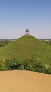 green cover ground iconic lion's mound waterloo belgium serene landscape natural area drawing drone panning shot leeuw van greenery historic beauty nature scenic attention 