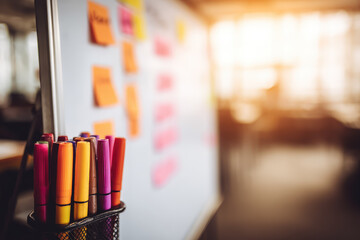 Hopeful planning for new year career goals on whiteboard with colorful markers and sticky notes. focused strategy session for creative business success and development