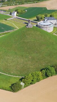 vibrant complete monuments areas buildings town along green grass trees open fields lion's mound waterloo belgium scene reveals circling drone shot leeuw van essence 