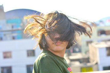 Preteen girl with messy hair covering eyes and forehead. 