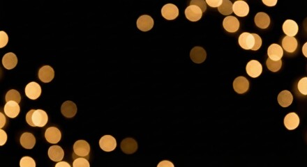 Golden bokeh lights shimmering on a dark background, creating a festive and magical glow